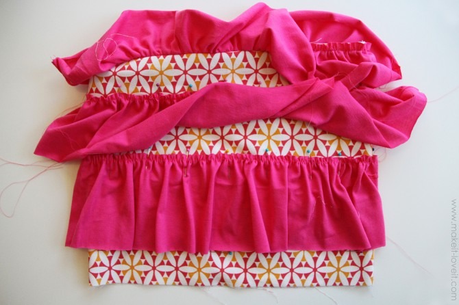 Next, sew your other two strips of knit fabric into circles, then add basting stitches and create ruffles…….just like you did above.  Then pin these next two rows of ruffles to the base fabric, evenly spacing them and overlapping them.  Pin in place.  