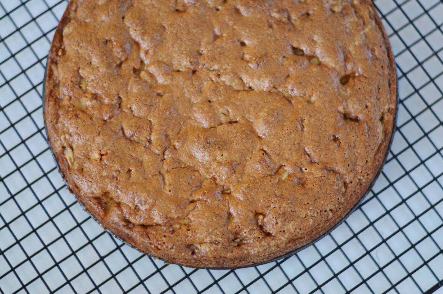 Preheat the broiler. Spoon the glaze over the top of the cake, allowing the excess to drip down the sides. Broil the cake 6-inches from the heat source until the glaze is bubbly, about 30 seconds. Set the cake in the pan on the rack to cool for 15 minutes.
