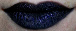 2. Use the greasepaint stick to line and fill your lips until the entire surface is matte and black. You should be able to get fairly good definition of shape using this. If you want, you can line beforehand with Feline e/k or any black pencil liner (chola status?) or afterwards to perfect the shape