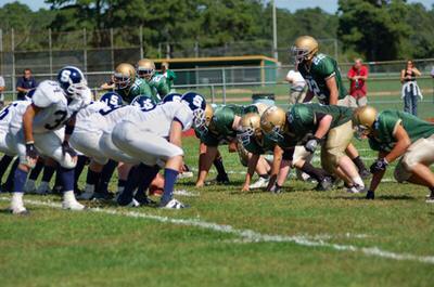 Football players must fuel their bodies properly prior to playing a competitive game. Photo Credit Football game image by Sirena Designs from Fotolia.com