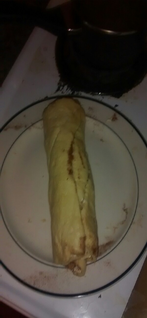 keep spreading margarine, sprinkling cinnamon and sugar on dough, and rolling until it resembles a log.
