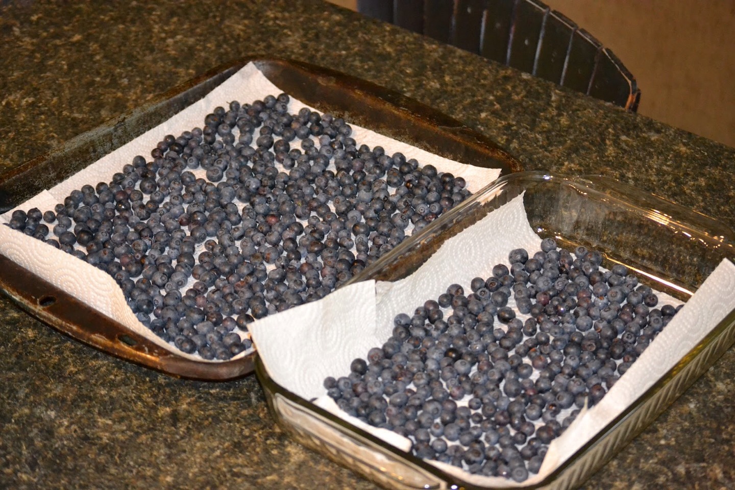 In order to freeze berries without squashing them, lay them out flat on a cookie sheet or baking dish