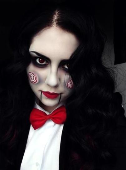 28. Experiment with dark-toned eyes and a red lipstick with two black lines. Paint circles on your cheeks in white and red hues.