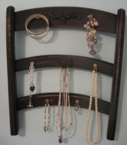 A cool wooden vintage chair with either nails or tacks to hold all sorts of jewelry 
