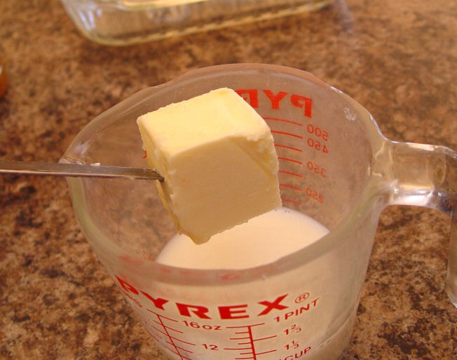 1. Pour your milk into a microwave safe container. These Pyrex glass measuring cups work fabulously. Add your butter to the milk and put it in the microwave for 1 1/2 minutes.
