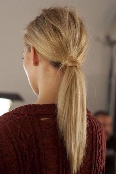 Hide an elastic by wrapping a strand of hair around the base of the ponytail and securing with a bobby pin. 

