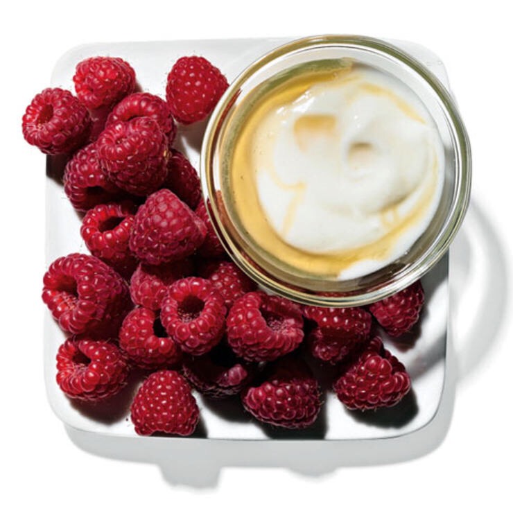 1 C RASPBERRIES WITH 2 TBSP PLAIN YOGURT AND 1 TSP HONEY
This sweet mix does the job until you can break away from your desk for a full meal.
