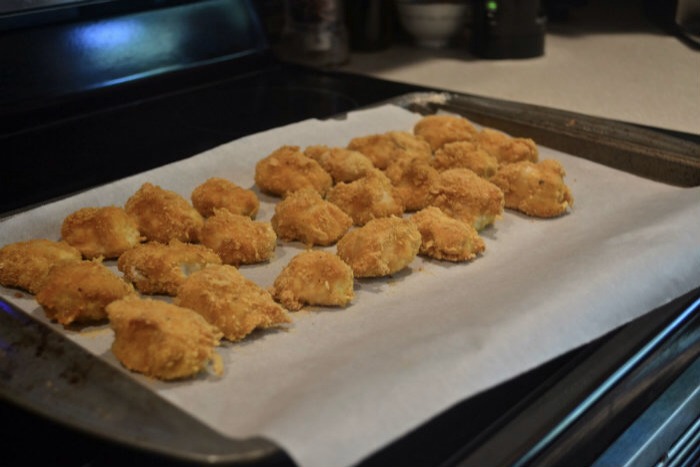 I dipped and cooked my nuggets in 2 lb batches.  You never know how long nap time will last in my house.

3) Coat each piece of chicken in flour.  Followed by the Egg.  Followed by the Cornflake Breadcrumbs. 

4) Bake at 350 f for 20-25 minutes 