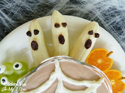 To make the BOOnanas you want to peel then cut in half. Use raisins for the eyes & mouth attaching with peanut butter...so so easy!