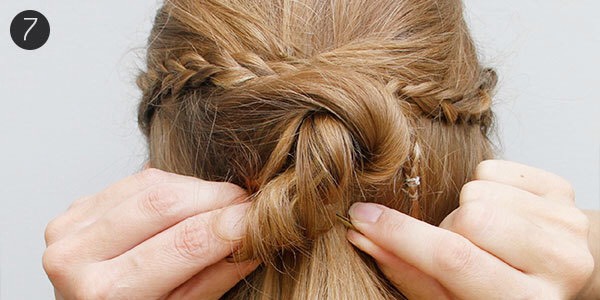 7. Now roll up the end to create one more pin curl. I like to create two pin curls out of one piece of curled hair to get more volume in the back. Continue like this until all the hair in the back is up. Arrange the pin curls to your liking.
