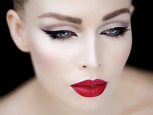 Bright red lipstick and 
Eyeliner with beautiful skin 