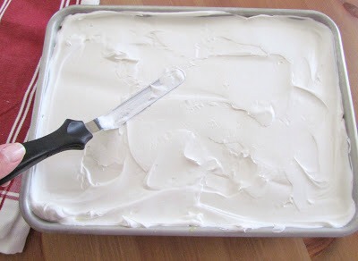 Put the pudding into the fridge to set and cool.
Once your cake has completely cooled, spread on whipped topping.