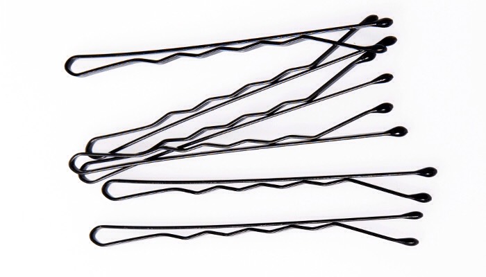 If you don’t want to bother with fixing and refixing your hair all day long, spray your bobby pins with hairspray before you put them in.