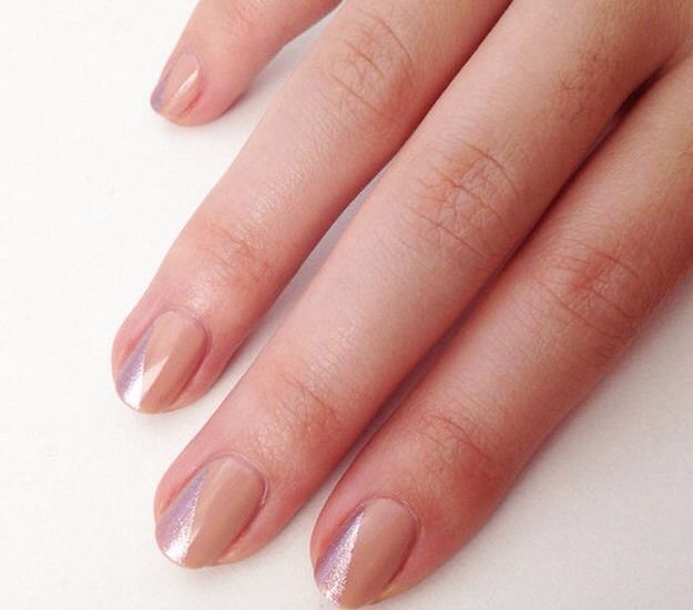 14. Minimalist Nude and Metallic Mani
An easy way to upgrade the standard nude nail, and all you need  is scotch tape! Start by painting your nails nude, wait for them to dry fully, then firmly placing a strip of scotch tape diagonally over the nail and paint in any metallic polish! Love this look!