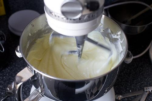 With mixer on low speed, add remaining 1 1/2 cups sugar in a slow, steady stream; scrape down bowl. Add salt and vanilla; mix until well combined. Add eggs, one at a time, mixing each until just combined and scraping down the bowl. Pour cream cheese filling over crust.

