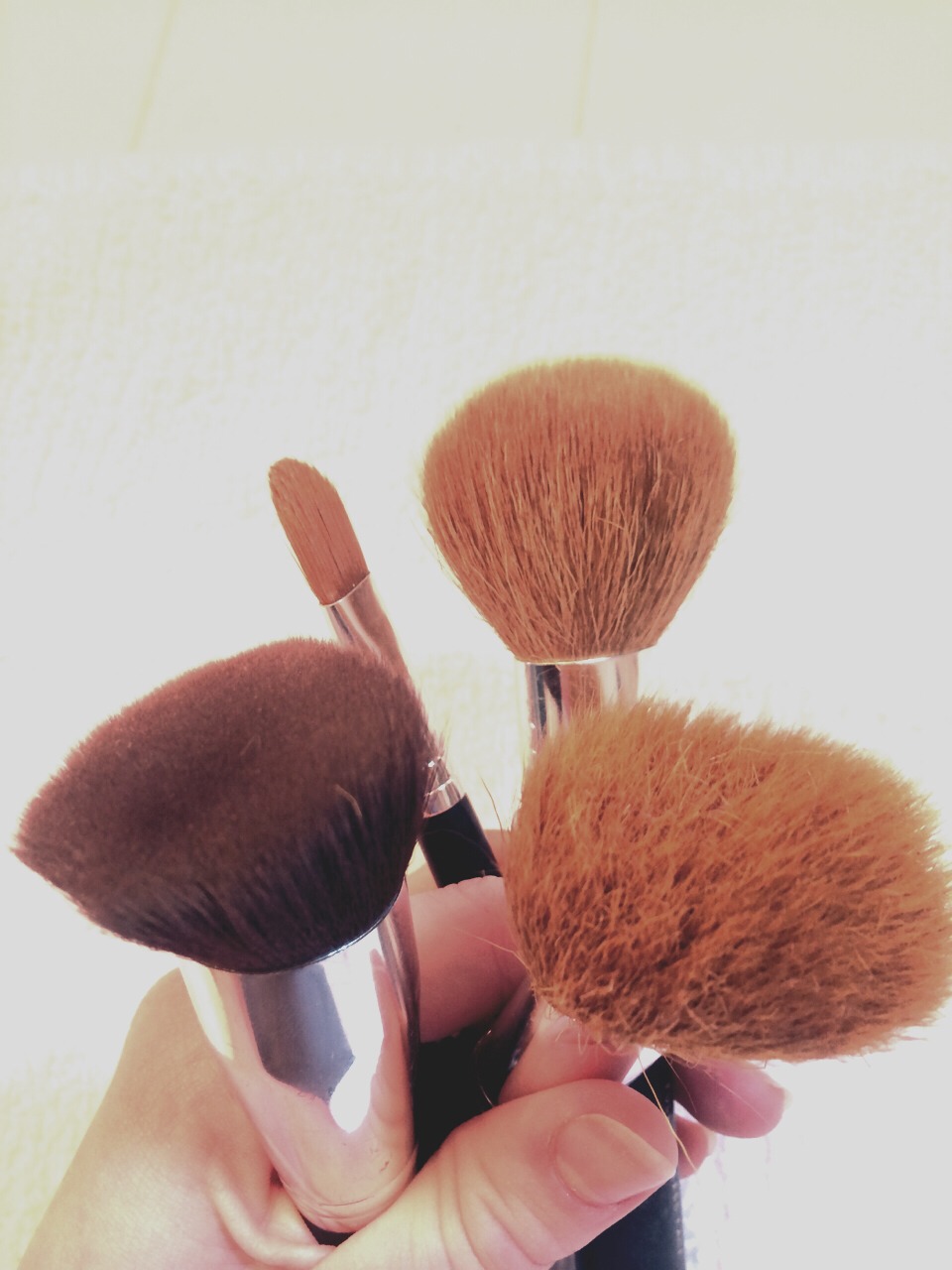 All sorts of built up bacteria and oils live in our brushes and sponges. When you try to cover up the spots, you could actually be putting the oils and bacteria BACK on your face and already vulnerable spots. Washing them weekly is a good way to help combat the breakouts and prevent new ones.
