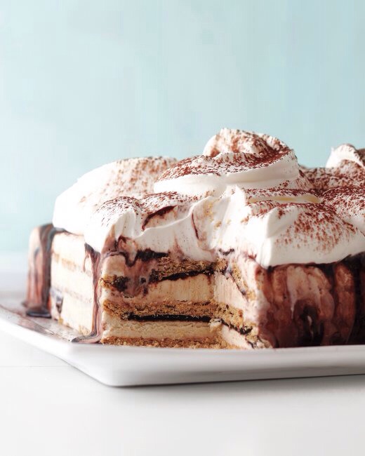 STEP 5
In a large bowl, using a mixer, whip 1 1/2 cups cream and confectioners' sugar on high until stiff peaks form, 3 to 5 minutes. Dollop cake with whipped cream and dust with cocoa. Serve immediately.