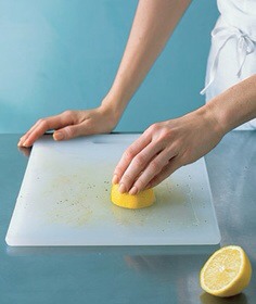 To remove tough food stains from light wood and plastic cutting boards, slice a lemon in half, squeeze onto the soiled surface, rub, and let sit for 20 minutes before rinsing. The best part? You'll have a house that smells like a lemon grove rather than chemicals.