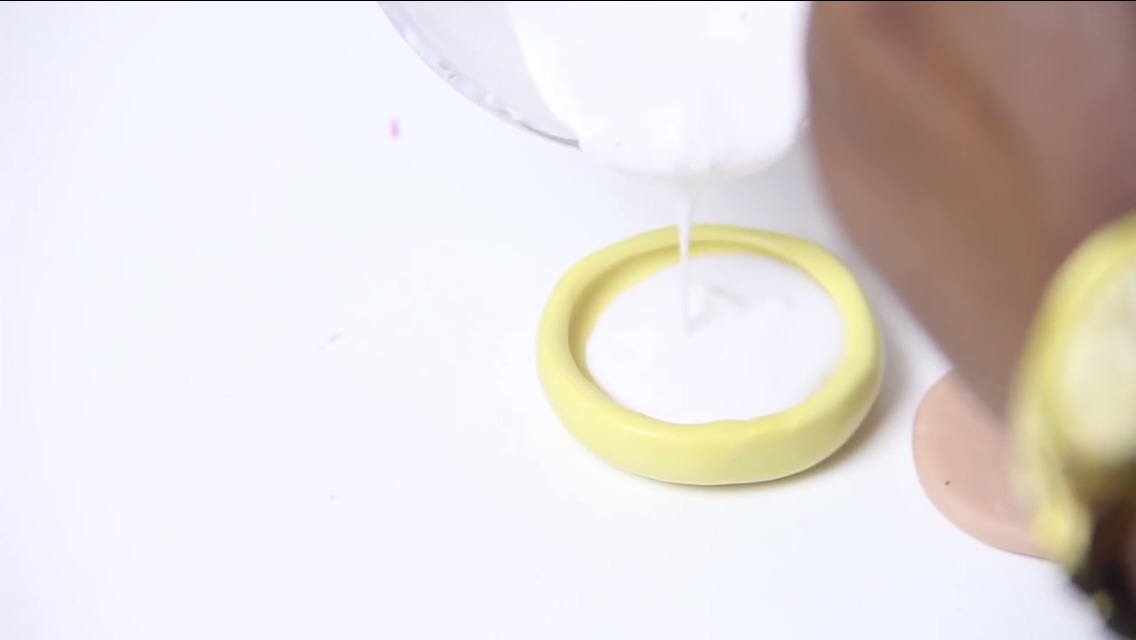 Then make white colored soap the same way as the black and pour it into your plain circle mold