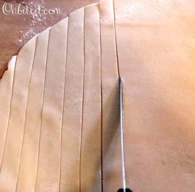 Top the caramel layer  with a layer of the chopped up Apple Pie Filling, making sure not to add too much pie filling…
Roll out the second sheet of Pie Crust the same size as the first sheet, and slice it into strips…