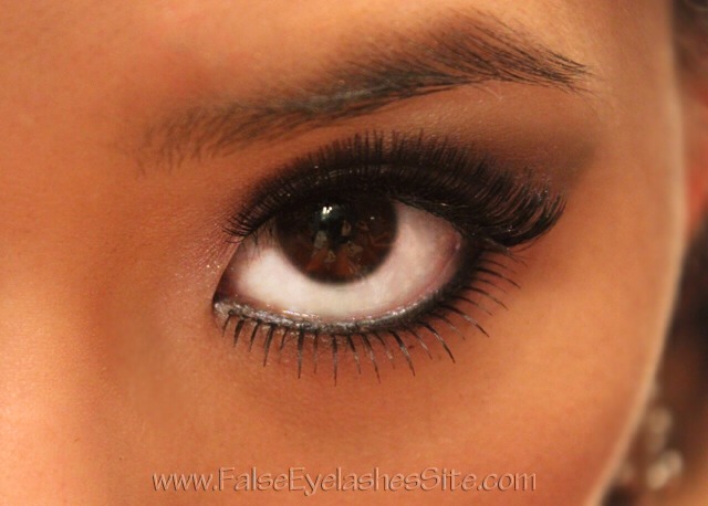 To finish up your eye look, add some false lashes to really make your eyes pop. To blend the false eyelashes with your real ones, apply the falsies, curl your lashes together, and apply a coat of mascara to seal them together. If there are any gaps or any glue showing, cover it up with eyeliner.