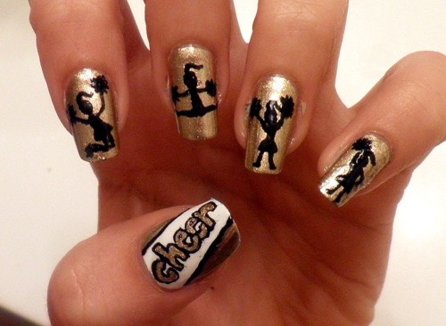 This nail design would be perfect for a cheer team with colors of gold,white,and black