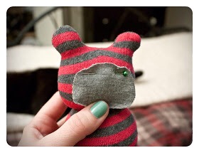 7. Cut out a piece from the other sock to create his little muzzle. Cut out an oval shape – I'd say close to the size of his face and then pin it in place.