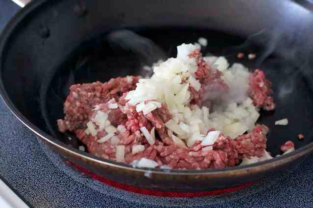 in a large pan brown the meat and cook onion