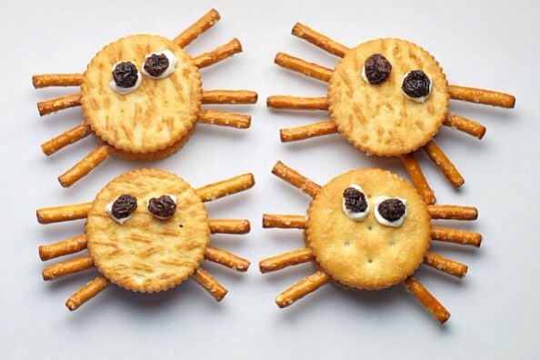 Take some crackers and add three pretzels on each side. Add raisins for the eyes. 