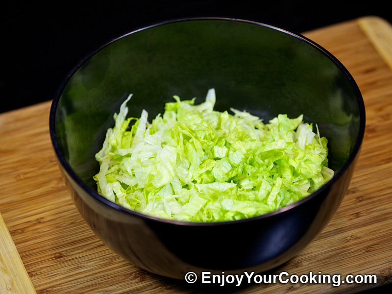 Tear up the lettuce and add into a separate bowl, along with slices of red onion, spring onion and cucumber. 5cm of cucumber counts as 1 of your 5 a day, so remember to include plenty! 