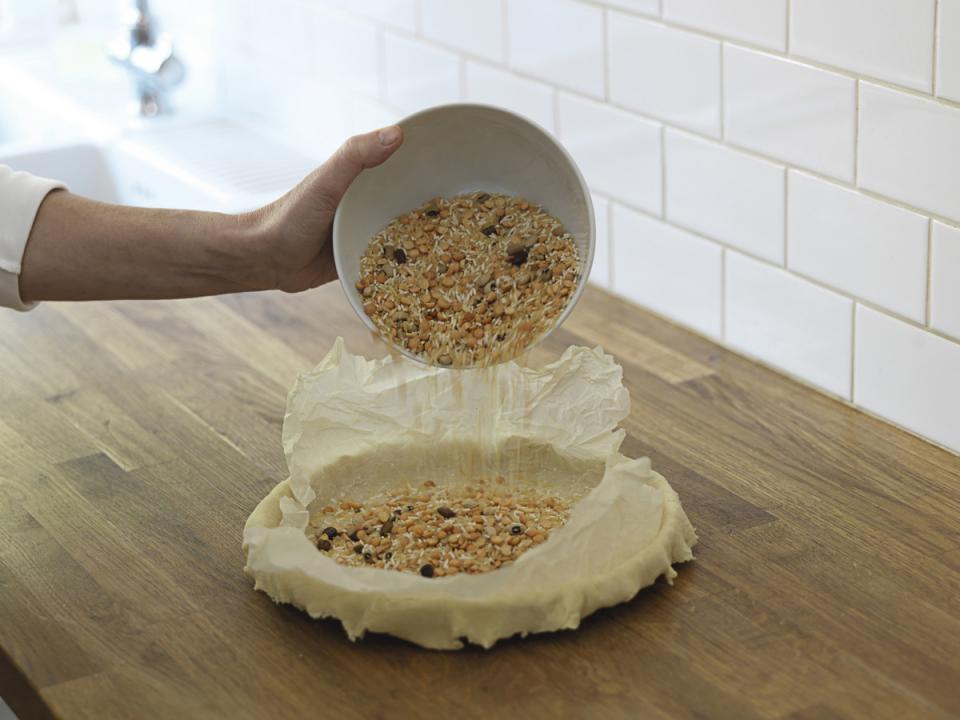 Use beans for pie weights. Not many of us bake pies on the regular, so we don't have things like pie weights and shields on hand. Luckily, there's no need. Use dried beans or rice in place of pie weights and fashion yourself a pie shield out of aluminum foil.
