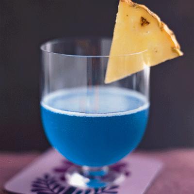 Blue Hawaiian

1½ oz coconut rum
2½ oz pineapple juice
1 oz blue curacao
pineapple wedge, for garnish
Combine coconut rum, pineapple juice, and blue curacao in a cocktail shaker filled with ice and shake vigorously. Strain into a chilled martini glass. Garnish with a pineapple wedge