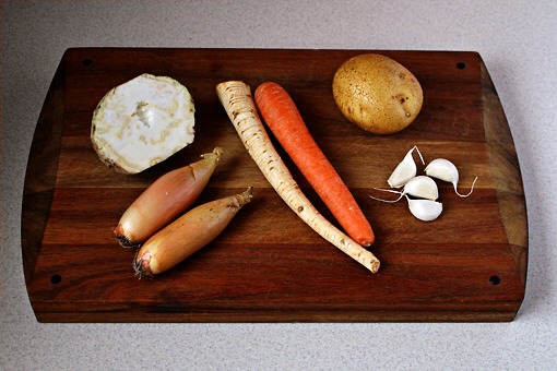 7.In the meantime, you can prepare your vegetables.
What we have here is the celery root, onion (I am using shallots here because life gets interesting sometimes and you might not find onions in your fridge but you don’t give up on your dream anyway), parsley root, carrot, potato and garlic cloves.