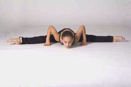 leaning very far forward in straddle almost middle splits.