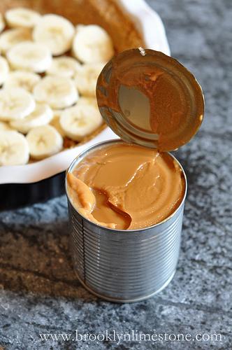 Open toffee can, mix with knife until smooth, pour on bananas. 