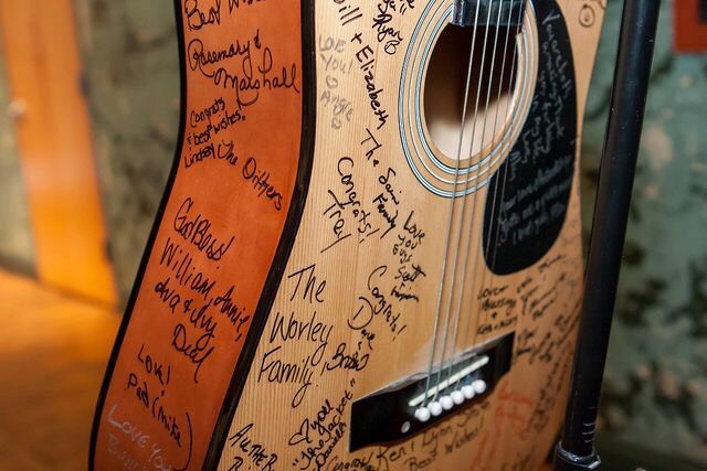 Have your guests sign an acoustic (or electric) guitar in place of a guestbook!