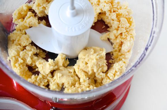 In the bowl of a food processor fitted with the pastry blade, pulse together the flour, sugar and salt. Add the cold, cubed butter and pulse just until the butter is incorporated and the mixture is in large clumps. Spray a 9-inch nonstick tart pan (with removable bottom) with cooking spray.