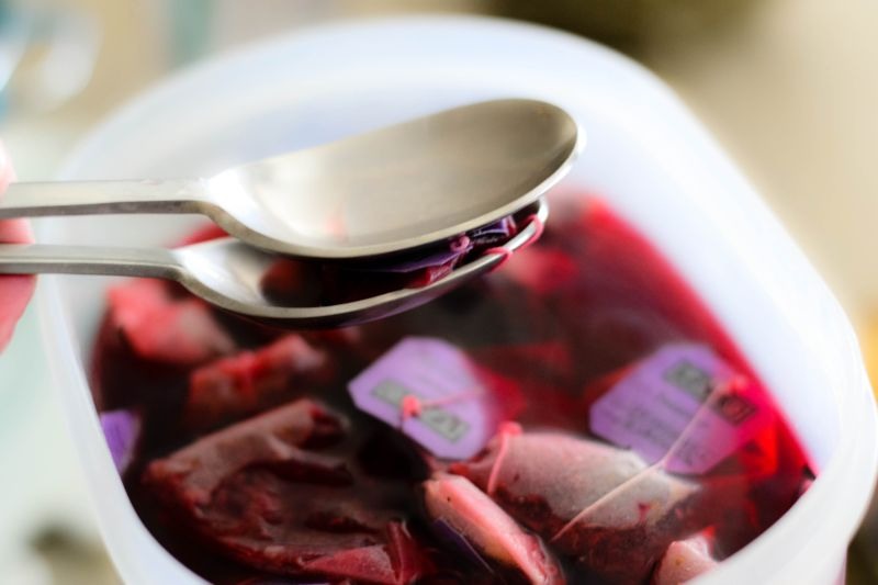 Take another spoon and squeeze out more flavour from each bag and toss.