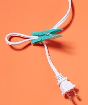 Clothespin as Cord Holder
Keep a retractable cord from rewinding too soon. Just clip the cord near the opening to prevent the cord from being sucked back in too quickly.