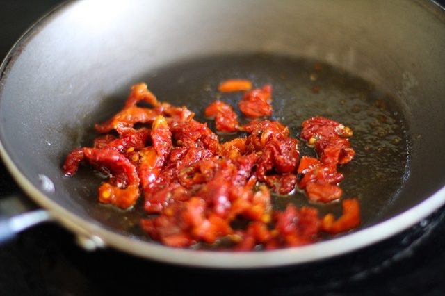 Step 3. Add the oil and chopped sun-dried tomatoes to a skillet over medium heat. Cook for 1 minute, stirring occasionally or until fragrant.