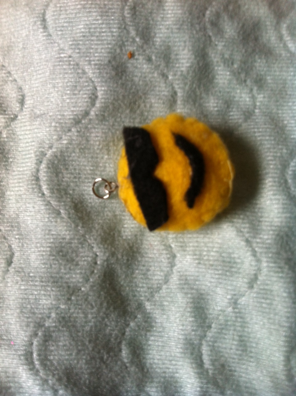 Wait for the glue to dry and then attach a jump ring to the eye pin