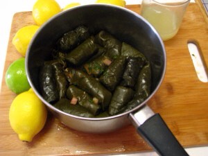 Take a medium sized pot and line the bottom with sliced carrots or potatoes. Make sure they are sliced flat and have the same height. This forms the base for placing the rolled stuffed grape leaves.
Place the rolled grape leaves on the sliced carrots making sure they are compact.