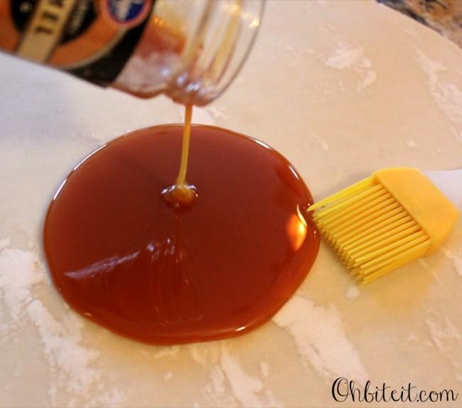 Pour some of the Caramel Sauce (Just enough to coat the crust) onto the crust and evenly spread it around, creating a thin layer of caramel