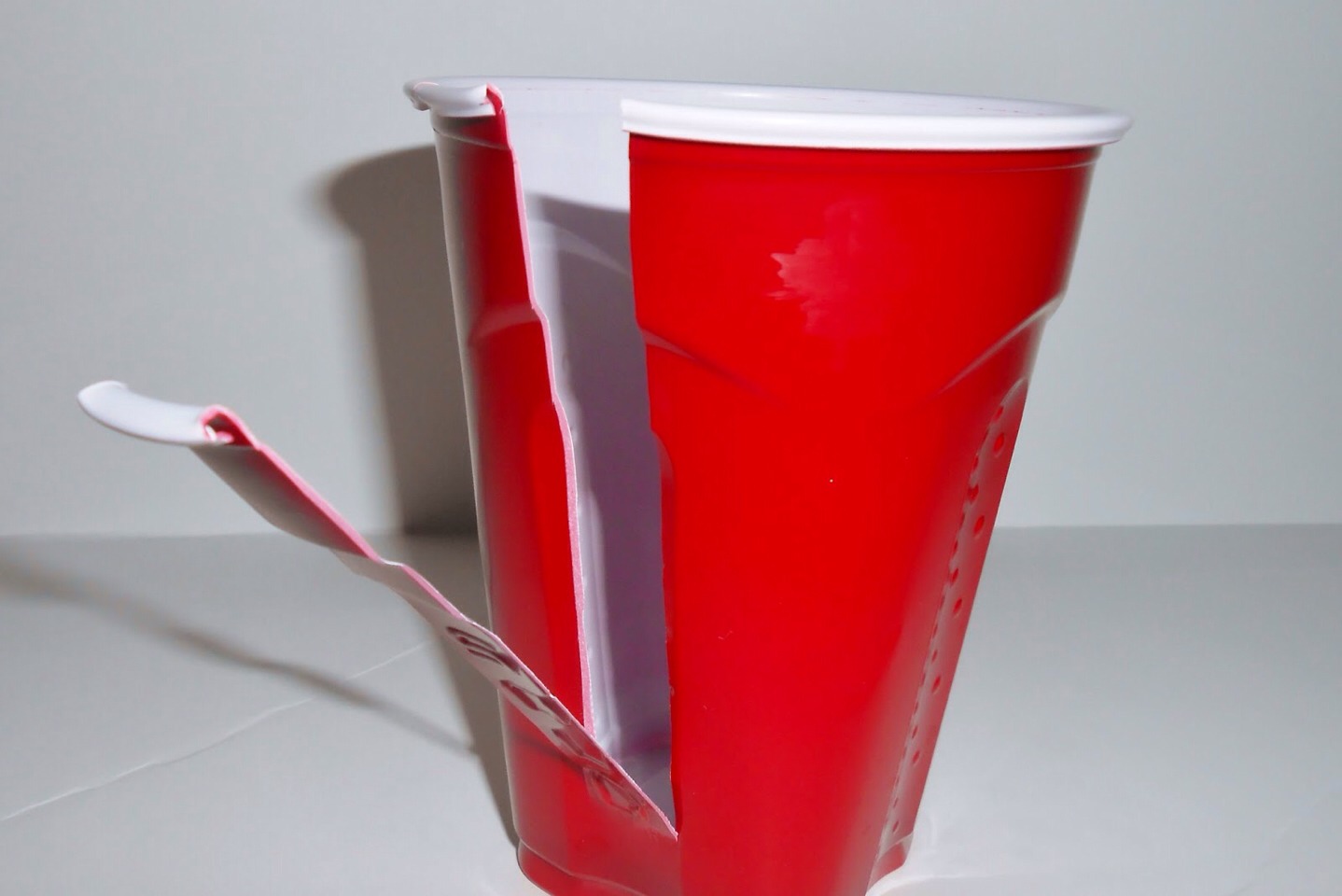 WHEN IT IS PURE ICE...you have to CUT IT OUT! If u don't ull crush it! So a box cutter knife or scissors to make an inch cut at top then pull away strips! And in  a minute ull have it out of the cup perfect form!!