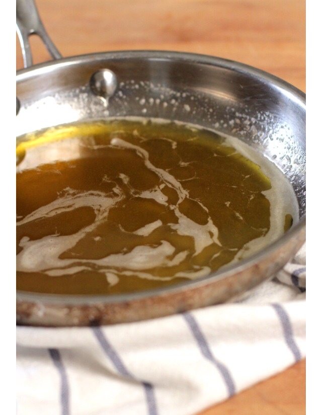 Step 3
Return the infused oil to the pot (be sure to clean out any remaining dried herbs). Over low heat, add the beeswax, stirring until melted. Add the honey, stirring for about a minute. Turn off the heat and add the essential oils (tea tree and lavender)