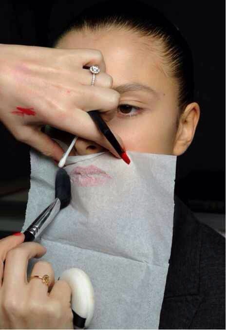 Once you've put on your lipstick, put some tissue over your lips and lightly dust translucent powder over with a brush