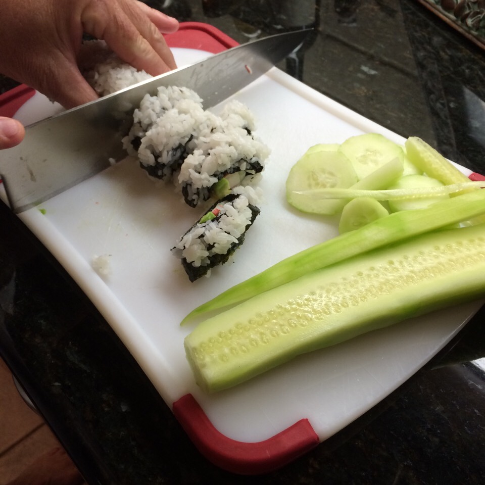 Carefully cut the overhangs of fillings on the ends off, using a fine edged knife. Then cut the roll into equal slices. The final project should look similar to this. Remember to keep refrigerated and do not keep for too long. Now that the California roll is complete, enjoy!