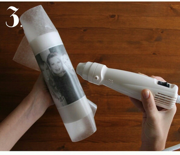 Step 3: Place your tissue-paper image on the candle and wrap a piece of wax paper tightly around both.  Tip: Make sure and make the wax paper tight, otherwise you little creases will be melted into your candle.