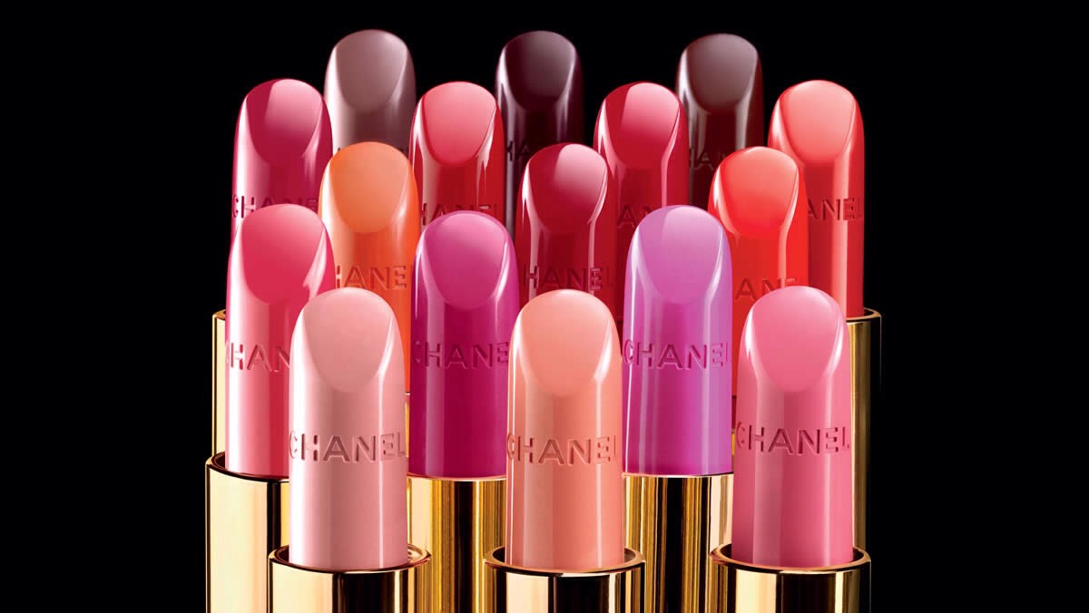 Before applying lip stick from an arms distance away spray a light mist of hair spray over stick and then apply to lips. It prevents lip stick from sticking on your cup when drinking 