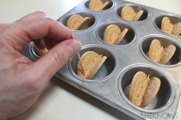• Smooth out with a toothpick. Allow them to cool a few minutes. 
• Turn the cookie taco shells over and pipe more peanut butter melt on the bottoms, smoothing the gap shut and securing the two wafers together.